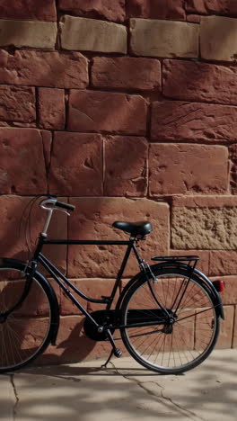 vintage bike leaning against a brick wall