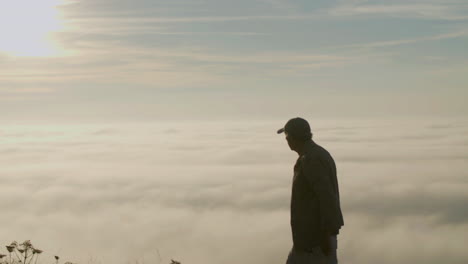 senior hiker walking on the mountain, then taking photo of the beautiful view