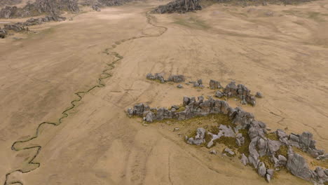 drone flies forward and tilts up from river tributary to the andes mountains in central peru