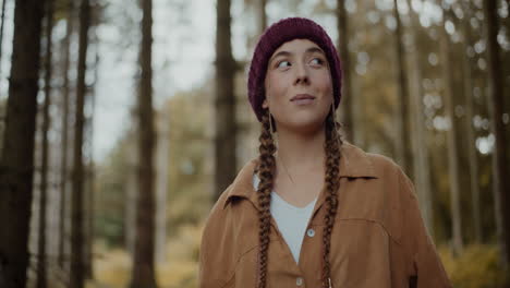 woman looking around in forest during vacation