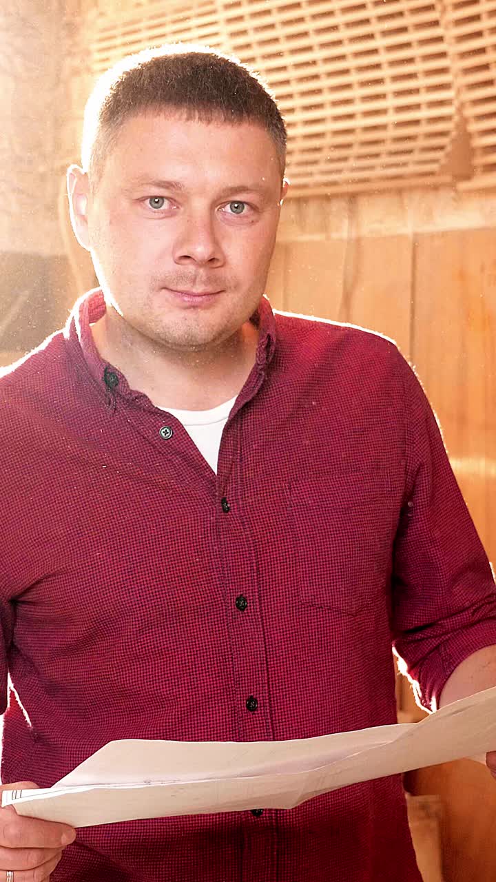 Brightly lit man holding paper in a sunlit room with warm wooden textures and soft ambiance