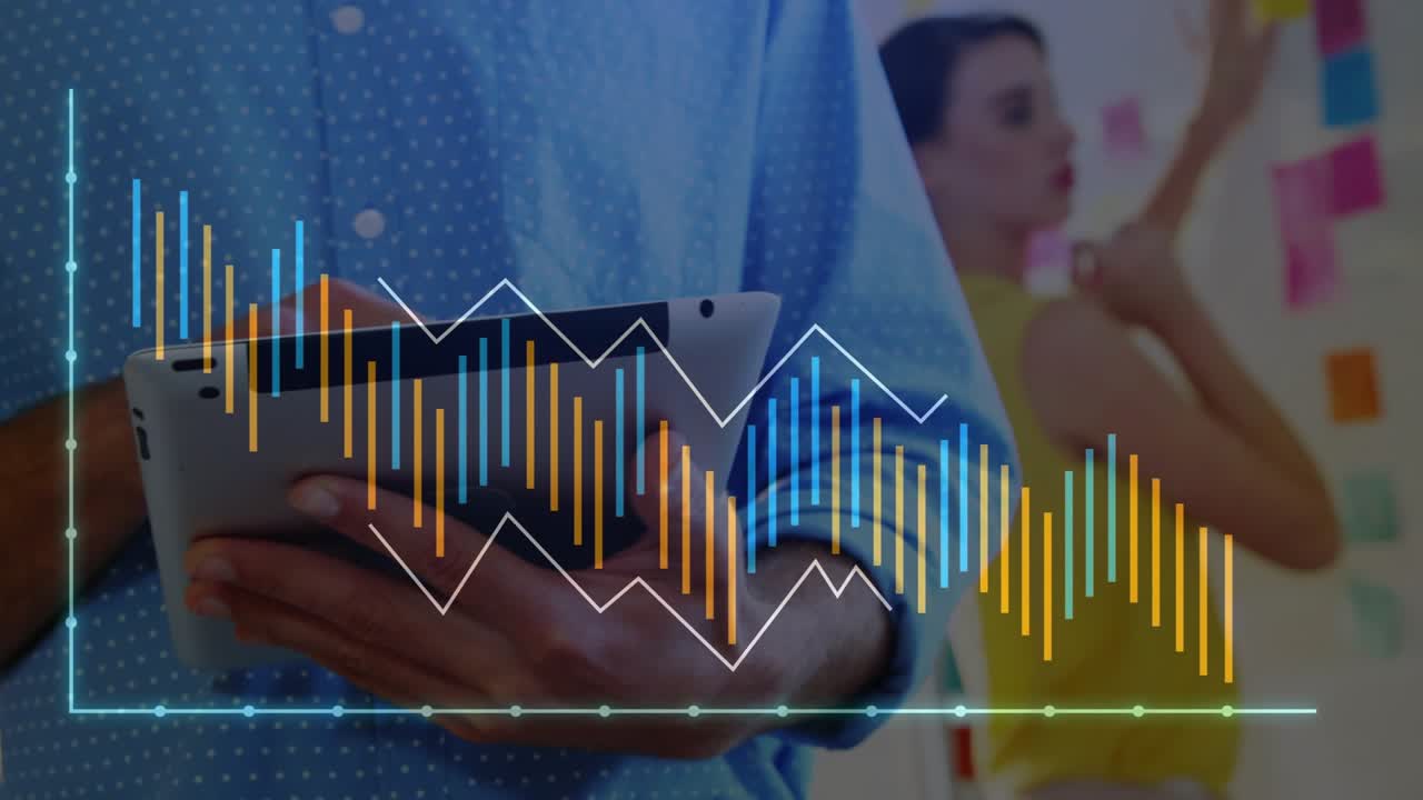 Man tapping tablet and updating translucent bars in tech office while coworker arranging notes