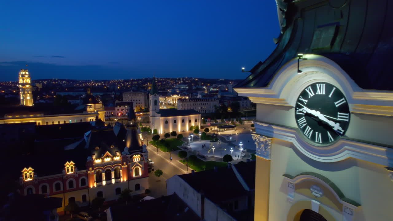 Areal drone view of the Cathedral of St. Nicholas in Oradea downtown at night, Romania. Unirii Square on the background, illumination