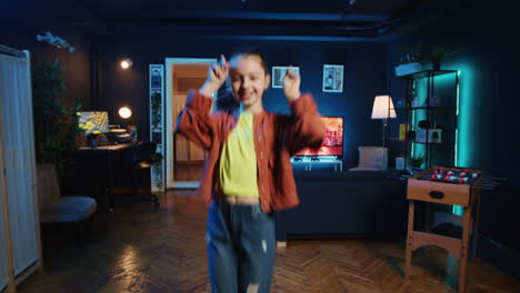 cute kid pressing record button on filming equipment, doing dance tutorial