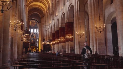 inside a grand historic cathedral with worshippers