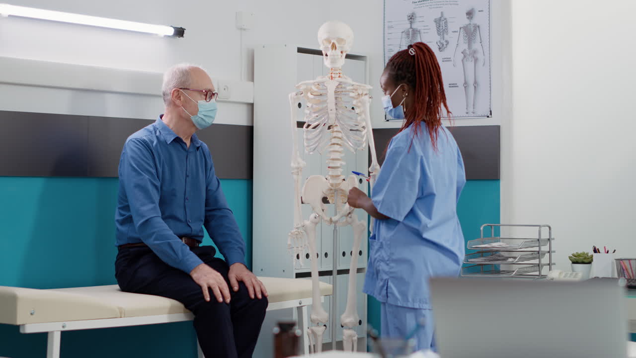 Doctor explaining human anatomy to patient using skeleton model