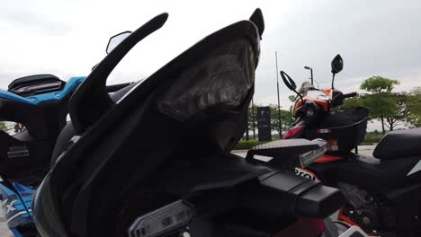 malaysia, kuala lumpur, march 12, 2022 - a stunning display of two honda motorcycles in vibrant blue and orange colours. motorcycle output from the manufacturer honda. detail from behind shoot