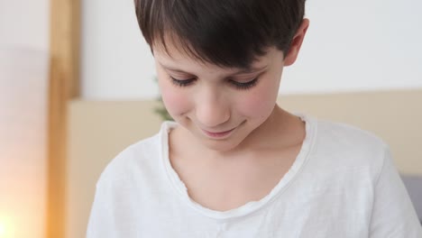 boy inserting coin into piggy bank