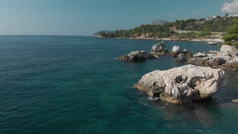 low drone shot around sea rock in sunny day-1