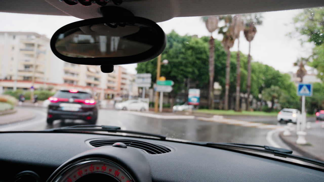 Antibes, France - May 8, 2025: View from the windshield of a car driving on the streets of the city