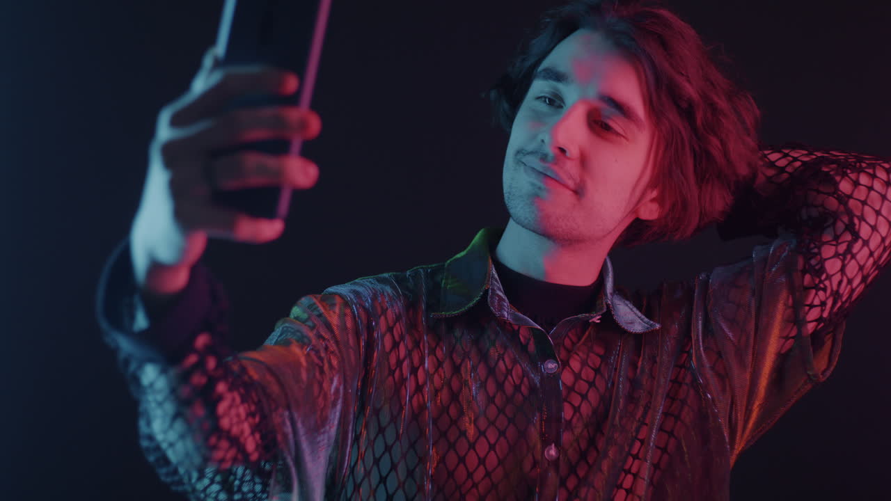 Man Taking a Selfie in Neon Light