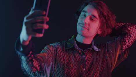man taking a selfie in neon light