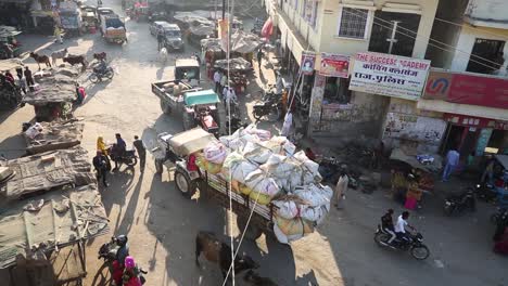 authentic real life scene of dooni indian city market central square with people and traffic in india. aerial handheld view