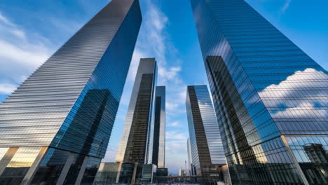 low-angle view of modern skyscrapers against a blue sky