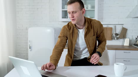 young man freelancer using laptop. businessman working on laptop from home office