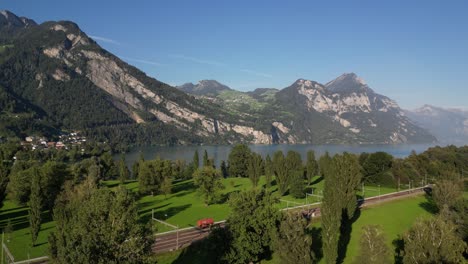 footage flying towards a breathtaking mountain range near a lakeside estate