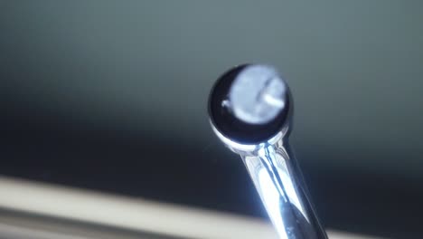 pouring water into a glass from a running faucet