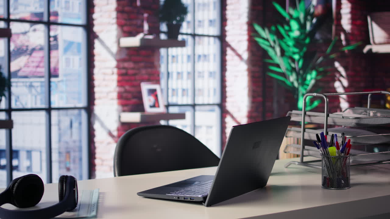 Modern Office Workspace with Laptop and Headphones