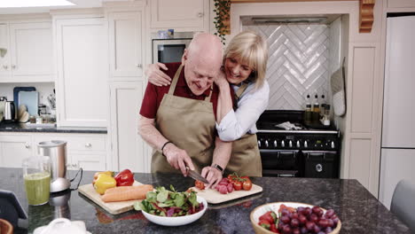 elderly couple cooking together in the kitchen