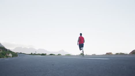 african american man wearing sportswear running on the road