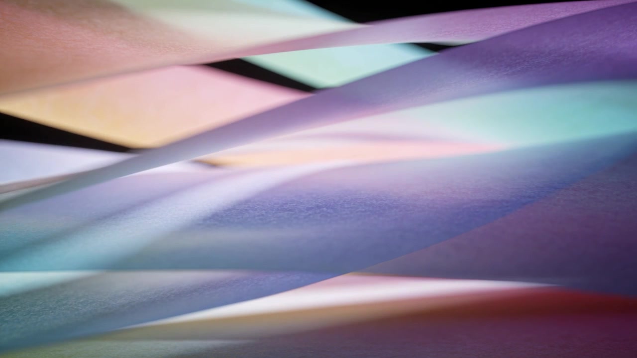 Shifting pastel lights causing curved paper strips sliding in studio table, revealing center gap