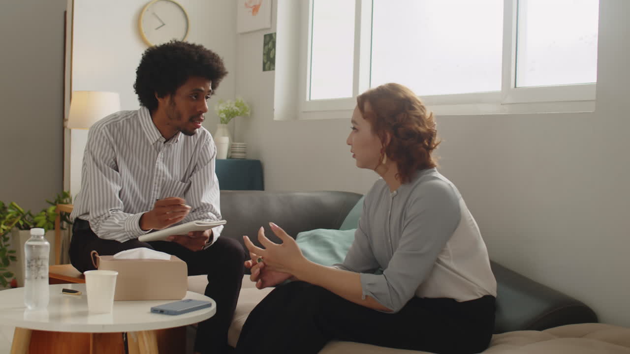 Male Psychotherapist Asking Woman about Her Problems