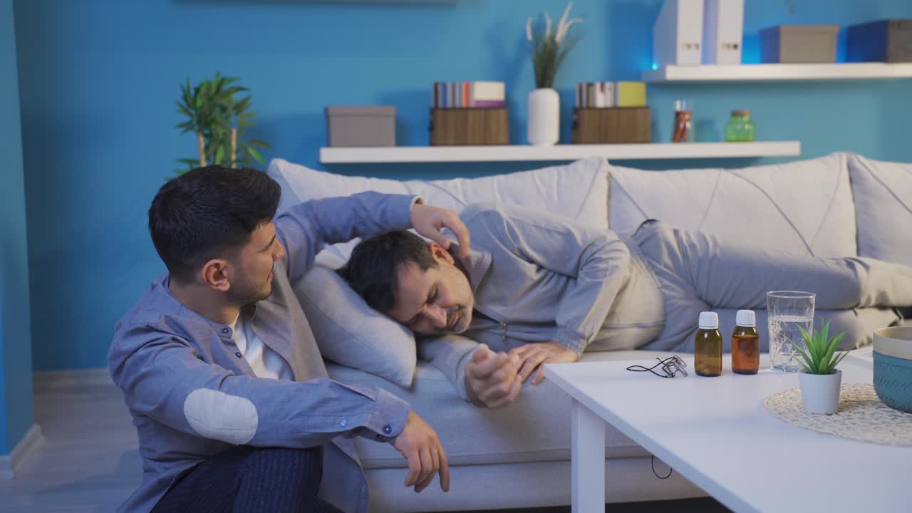 Adult son waiting next to his sick father.