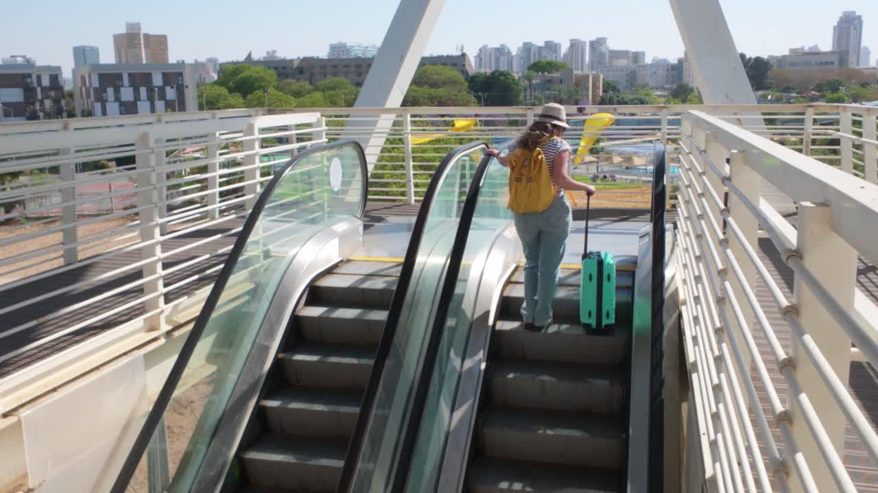 Tourist Rides Up the Moving Stair