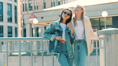 two women smiling and laughing in a city street