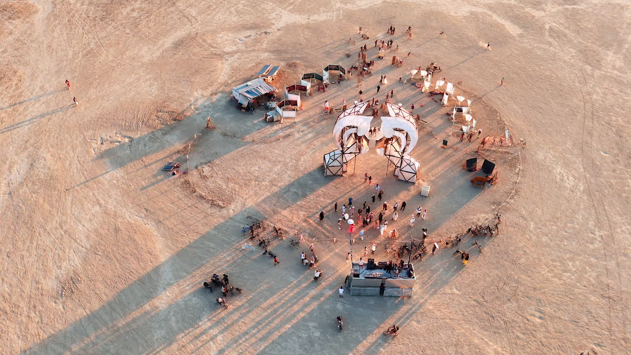 Nevada, USA, 14 August 2025: Aerial view of Burning Man art installation and people in Nevada desert.. A drone captures an art installation surrounded by participants and bicycles