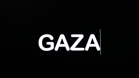 typing the letters for the name gaza in boldface, and uppercase as shown on a black background of a computer's screen