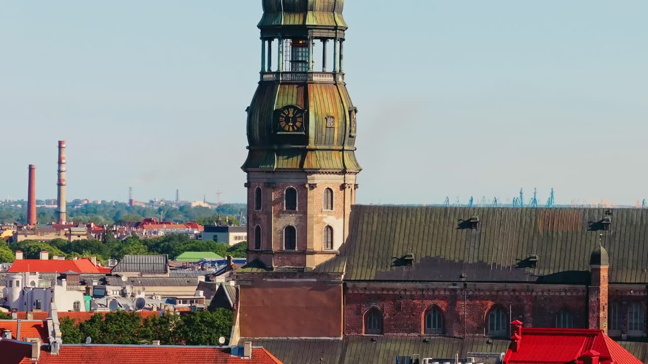 Drone moves sideways with close telephoto view of Riga St Peters Church tower
