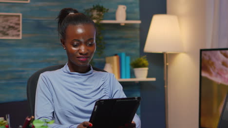 african american businesswoman taking break using tablet