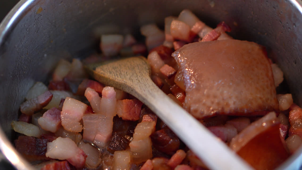 Greasy Pork Fats Cooking In A Stainless Pot. close up, dolly-out shot