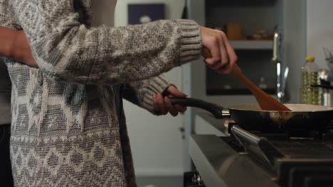 caucasian woman cooking in her house