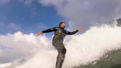 surfer riding tropical blue ocean wave surfing with power