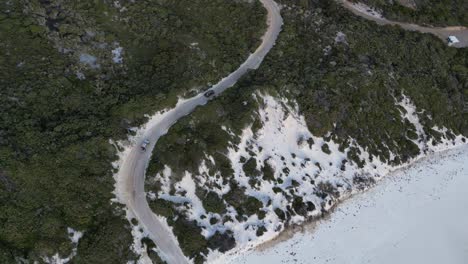 vehicles driving along road near wharton beach, western australia