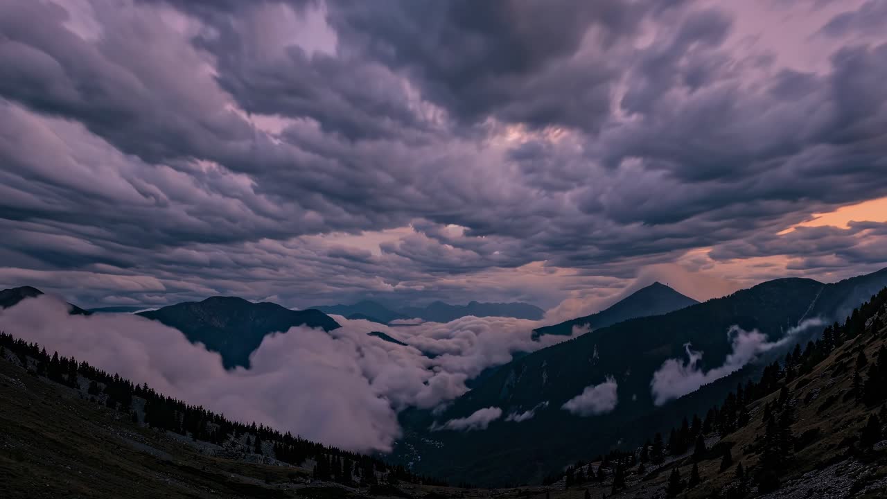 Dramatic wide-angle shot of a mountainous landscape at dusk, with swirling clouds and mist