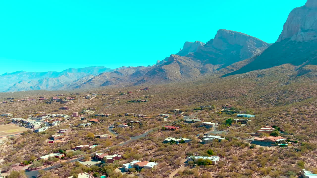 Cinematic panning drone shot of homes and mountains in Tucson Arizona
