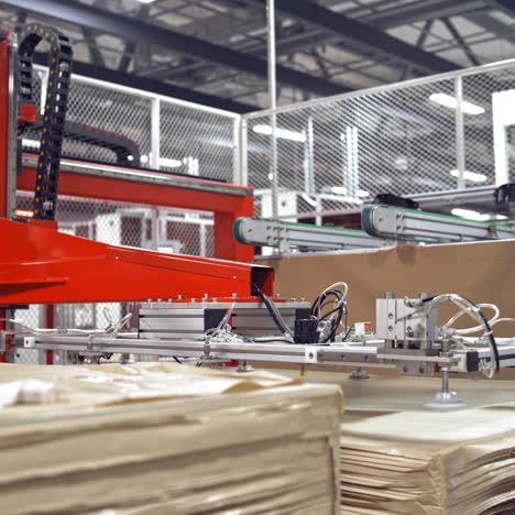 automated factory equipment at working process. special machine is rising panels up on a contemporary background of industrial plant.