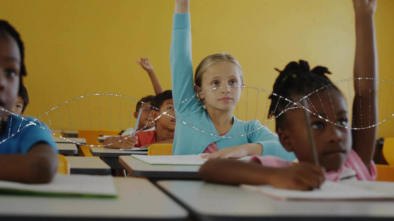 five students sitting classroom desks holding pencils, raising hands after teacher posing question