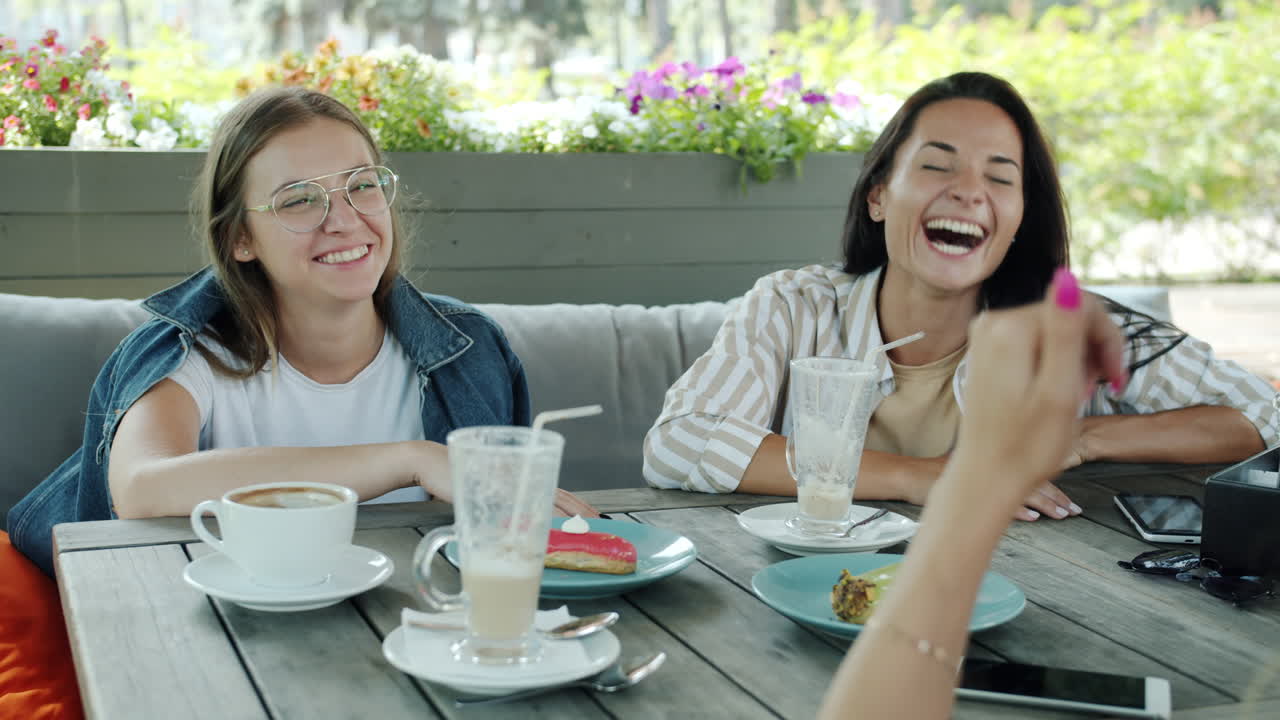 Friends Enjoying Coffee in Outdoor Cafe