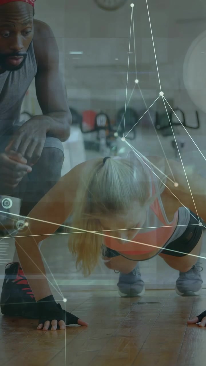 Vertical video: Trainer cueing female trainee doing push-ups, HUD overlay tracking form for fitness
