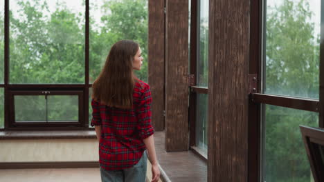 lady gazes through panoramic windows young woman finds comfort in quietude of own company solitary