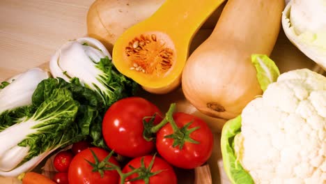 assorted vegetables arranged on a wooden surface