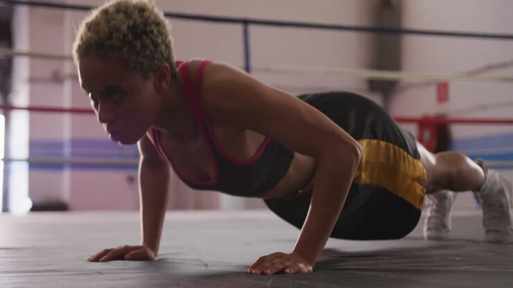 Mixed race woman working out in boxing gym