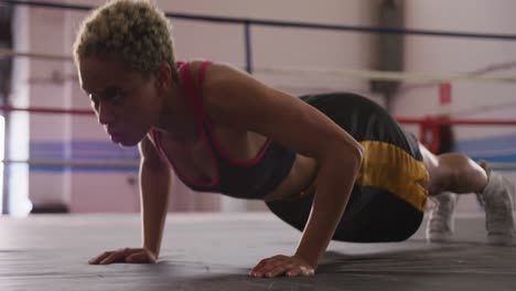 mixed race woman working out in boxing gym