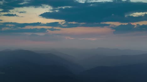 the flight above foggy mountains on the sunset background. hyperlapse