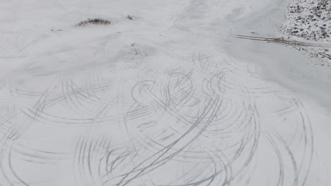 drone captures intricate car tracks left by drifting cars on the icy surface