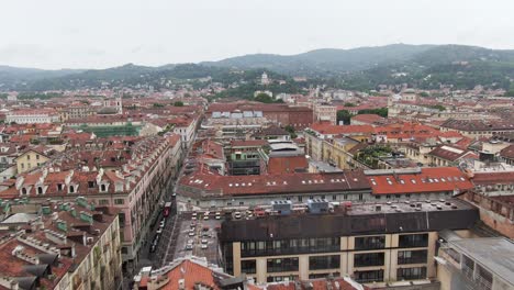 Narrow-streets-and-colorful-rooftops-of-Turin-downtown,-low-altitude-drone-flying